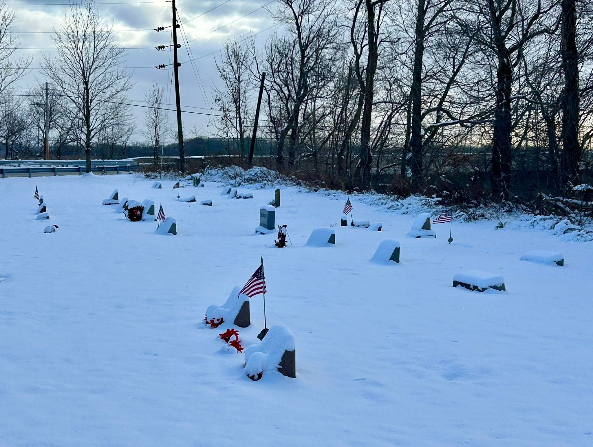 Flags and flowers beside cemetery markers
